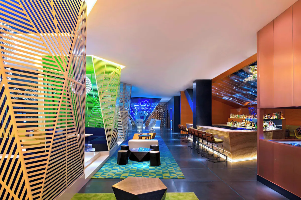 Modern hotel room interior at W Mexico City featuring sleek furniture, ambient lighting, and city-inspired design elements.