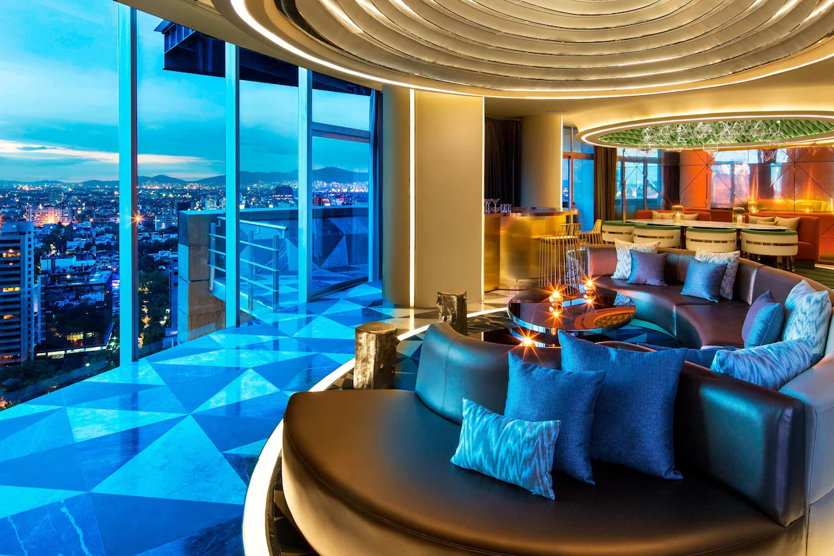 Modern suite interior at W Mexico City featuring pastel accents, ambient lighting, and sleek furnishings—ideal for upscale urban stays.