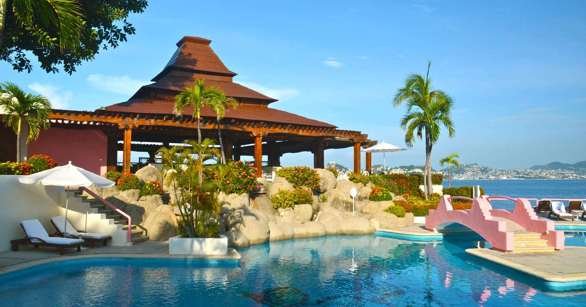 Cliffside casita with private pool overlooking Acapulco Bay, iconic pink jeep parked nearby
